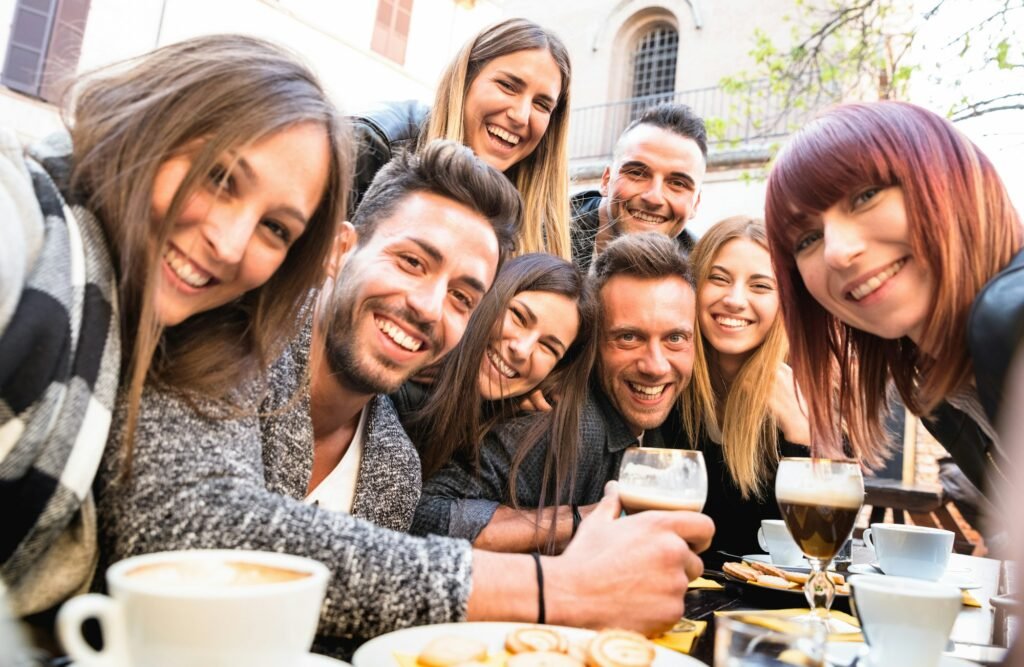 Friends taking selfie at bar restaurant drinking cappuccino and irish coffee