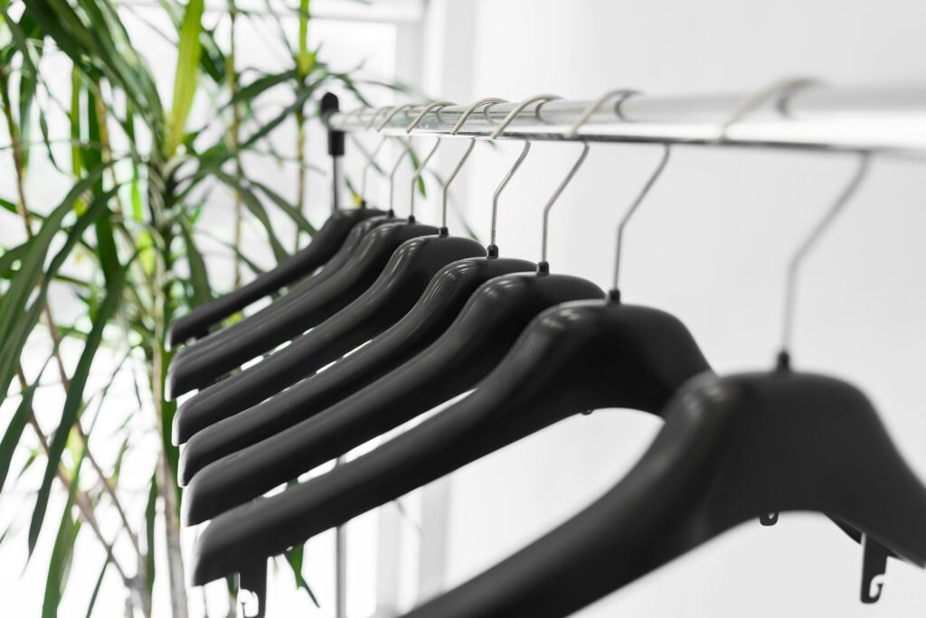 Plastic empty clothes hangers on rack